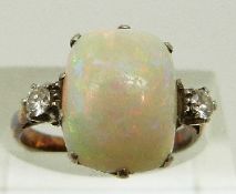 An 18ct gold ring set with an opal cabochon and two diamonds, size K, 3.