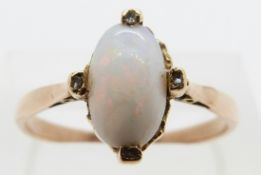 A 9ct gold ring set with an opal and four diamonds, size R/S, 2.