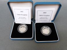 2002 and a 2003 £1 Royal Mint silver proof coin, Three Lions and Royal Arms examples,