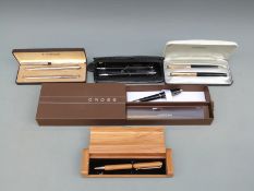 A collection of cased pens including two Parker sets
