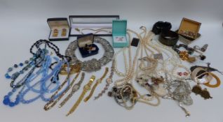 A collection of costume jewellery including silver plate belt, faux pearls, silver necklace,