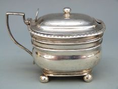 Georgian hallmarked silver mustard with blue glass liner, raised on four ball feet, London 1808,