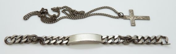 A silver cross and silver curb link bracelet