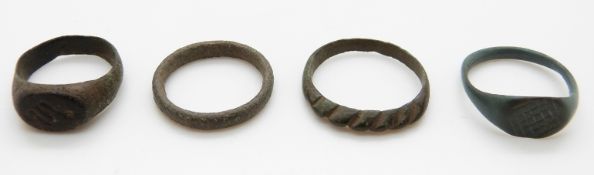 Three bronze Roman rings and a Viking ring one with stylized 'S' or snake