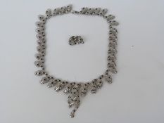 A costume jewellery necklace made up of graduating leopard heads set with clear and green paste and