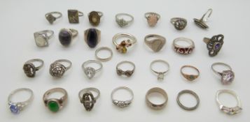Twenty-eight silver rings including amethyst set, marcasite, amber,