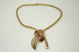 A 9ct gold necklace/ choker set with rubies in a stylised foliate design in original Mallory box,