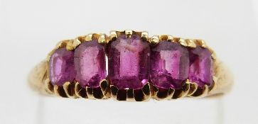 A late 19th/ early 20thC ring set with five cushion cut rubies, size N, 2.