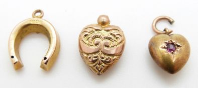 A 15ct gold heart pendant/ charm set with a ruby (0.