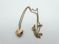 A 9ct gold necklace and a 9ct gold heart padlock, 4.