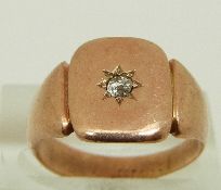 A 9ct rose gold signet ring set with a diamond in a star setting, size O, 4.