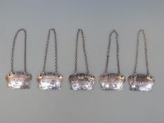 Set of five hallmarked silver bottle trinkets comprising whisky, vodka, brandy, burgundy, claret,