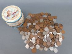 A vintage Huntley and Palmer Biscuit tin containing a collection UK coinage,