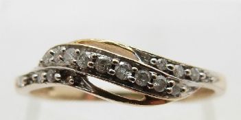 A 9ct gold ring set with diamonds in a twist setting, size N, 1.