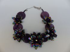 A Butler & Wilson necklace made up of alternating circular quartz and tiered flowers,