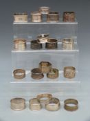 Nineteen Victorian and later hallmarked silver napkin rings, 321g and an Indian, or similar,