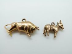 A 9ct gold charm in the form of a donkey and a 9ct gold charm in the form of a bull, 5.