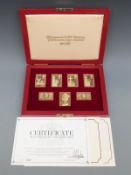 Cased set of seven hallmarked silver gilt replica stamps to commemorate the anniversary of the