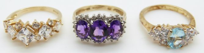 A 14ct gold ring set with cubic zirconia, a 9ct gold ring set with amethysts and another ring,