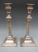 A pair of hallmarked silver Victorian neoclassical style candlesticks,