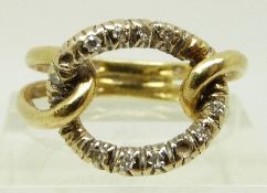 A bi-coloured ring set with diamonds in a knotted design, size O, 5.