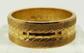 A 22ct gold ring/ wedding band with textured decoration, size L/M, 6.