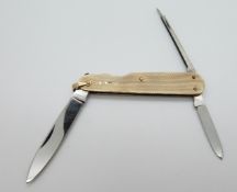 A penkife with 9ct gold engine turned casing