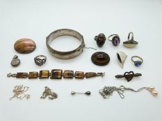 A collection of silver jewellery including a bangle, brooch,