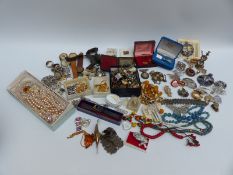 A collection of costume jewellery to include brooches, cufflinks, necklaces, Tissot watch,