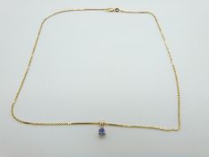 A 14k gold chain and pendant set with tanzanite,