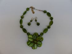 A Butler & Wilson necklace made up of green iridescent beads in the form of a large flower,