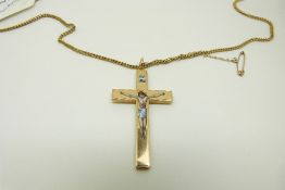 A yellow metal crucifix with enamel decoration, 4.