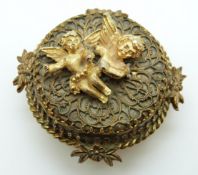 An Austrian musical brooch/pendant with applied cherub decoration
