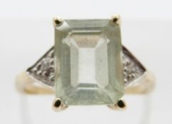 A 9ct gold ring with green topaz and two small diamonds either side, size K, 2.