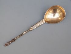 Possibly Dutch gilt white metal apostle spoon surmounted with a figure holding a child,