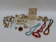 A quantity of costume jewellery including a 9ct gold and silver ring, earrings, brooches,