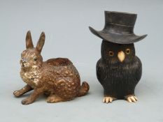 A cold painted pen wipe in the form of a hare and an owl inkwell,