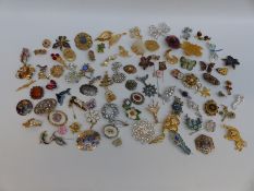 A large collection of brooches including floral, Sarah Coventry brooches, butterflies,