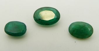 Five apple green oval cut emeralds, the largest approximately 0.