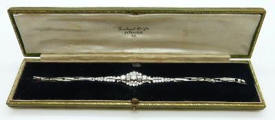 An early 20thC 18ct white gold bracelet set with round and baguette cut diamonds,