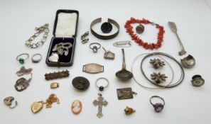 A coral bracelet, white metal earrings, filigree bangle, silver rings, silver locket, silver bangle,