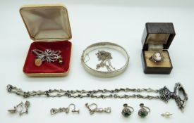 A silver bangle with matt finish, silver cameo ring, silver brooch, paste earrings,