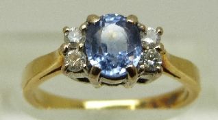 An 18ct gold ring set with an oval cornflower blue sapphire of approximately 0.