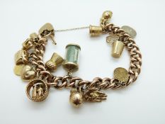 A 9ct gold charm bracelet with 17 9ct gold charms including 1 dollar coin, thistle, boat, heart,