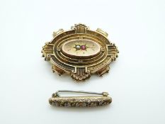 A Victorian brooch set with a ruby and pearl and a yellow metal brooch set with enamel flowers