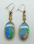 A pair of Victorian earrings set with black opal doublets with pierced backs
