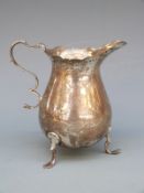 Modern hallmarked silver cream jug raised on three feet, Birmingham 1973, maker S.J.