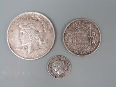 1924 USA Liberty Dollar together with a 'Lady Liberty' 1865 three cent coin and a 1942 Canadian 50