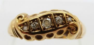 An 18ct gold ring set with five old cut diamonds in an unusual setting, Birmingham 1913, size N, 2.