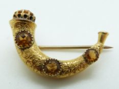 A 15ct gold Victorian brooch in the form of a horn set with citrines, 3.